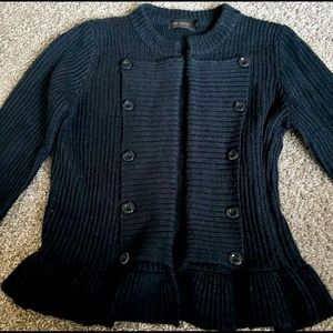 The limited black sweater with ruffle bottom